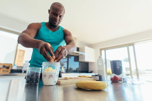 Post-workout recovery foods - a man preparing a protein shake.