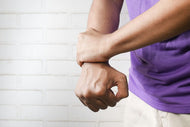 A man doing wrist strengthening exercises.