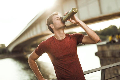 A man having a post-workout recovery drink.