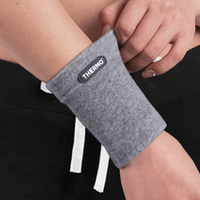 Thumbnail for slider2:A woman wearing a Thermo Wrist Sleeve for recovery